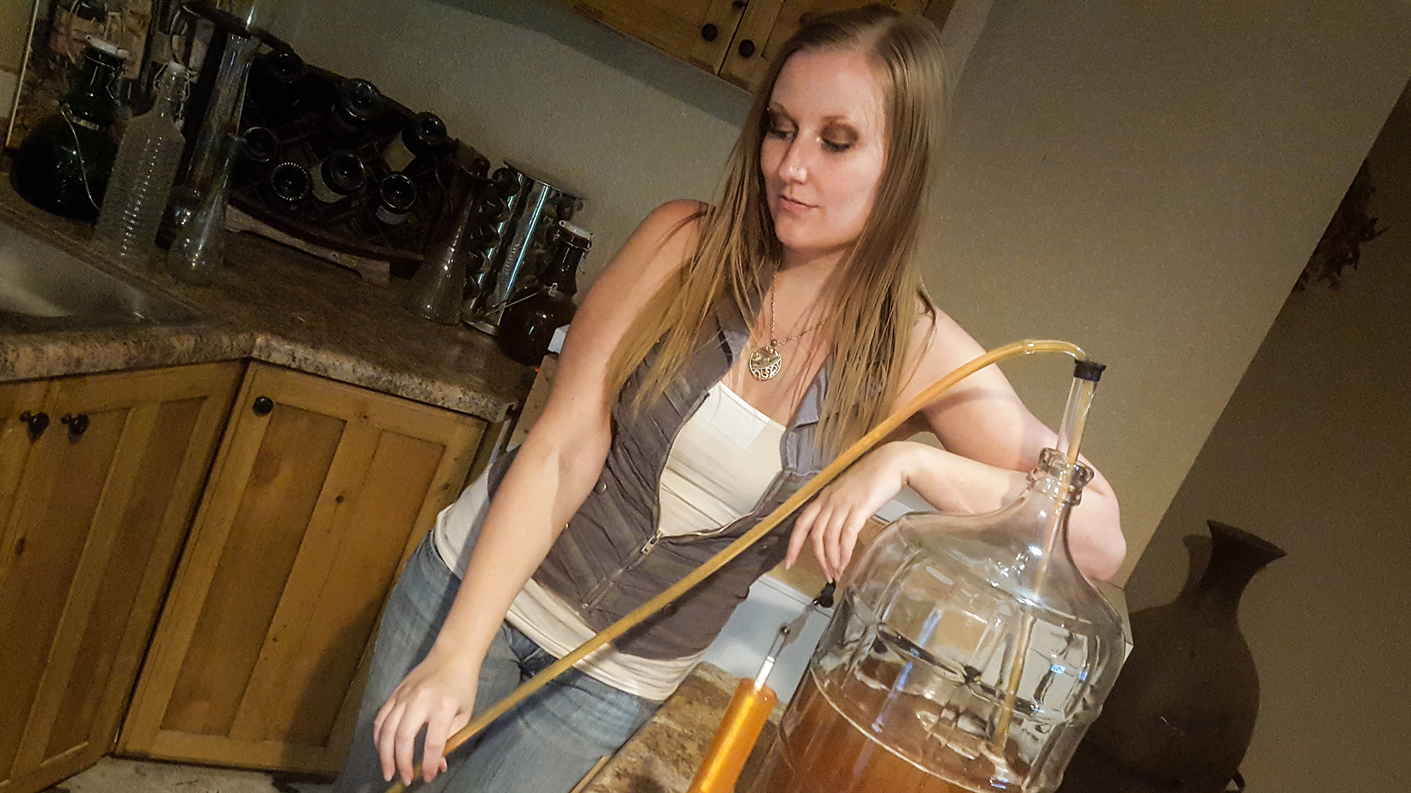Image of Mikenzie Tavenner Hardman brewing a new beer in her kitchen.